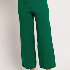 Green knit wide-leg pants and sandals.