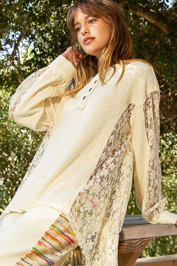 Cream lace-detailed long-sleeve top.