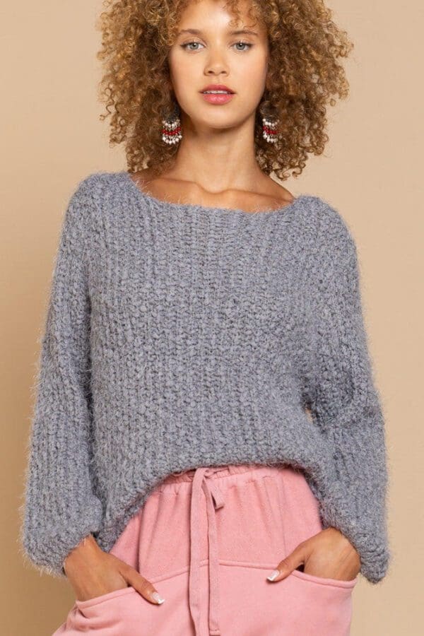 Gray fuzzy knit sweater, model.